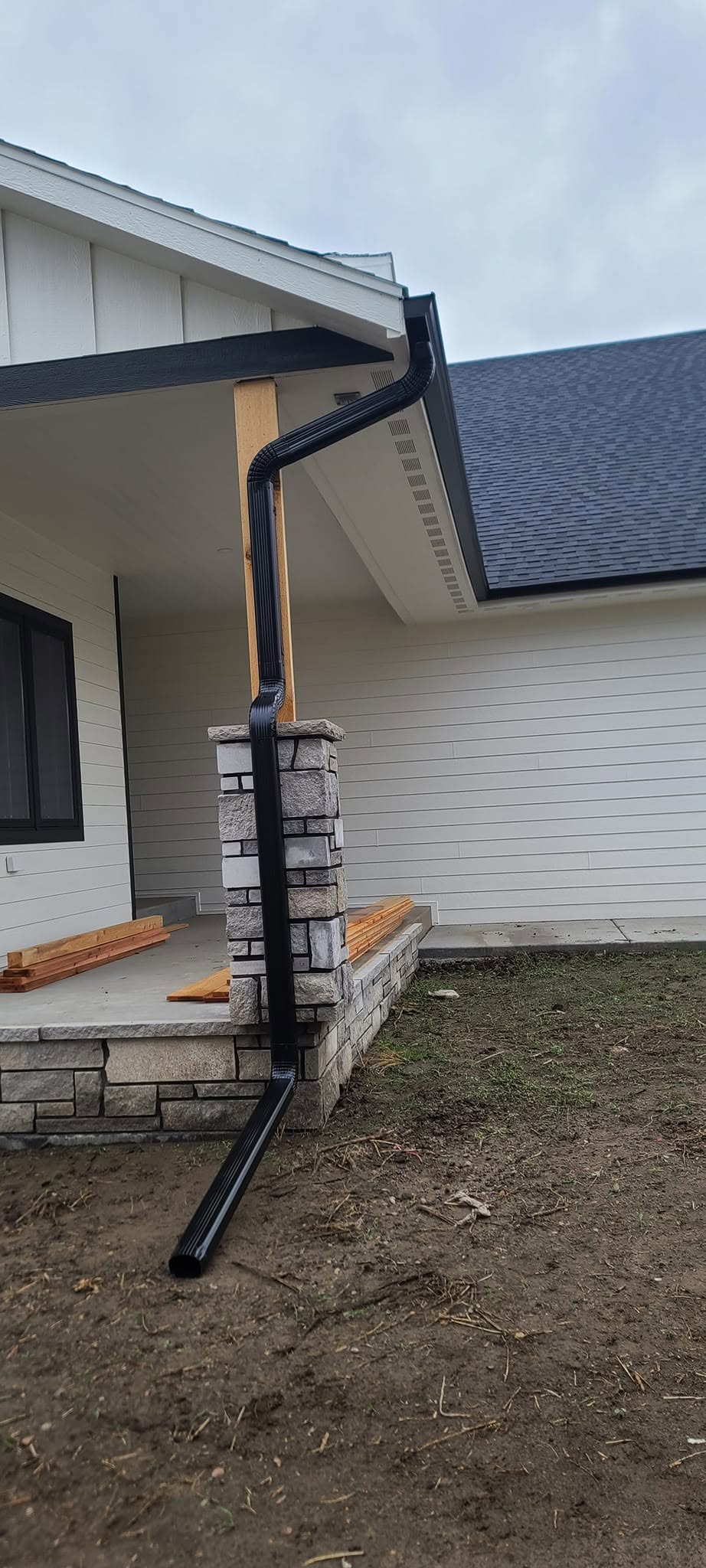 United Roofing & Siding black gutter downspout installation for a residential home in Sioux Falls, SD