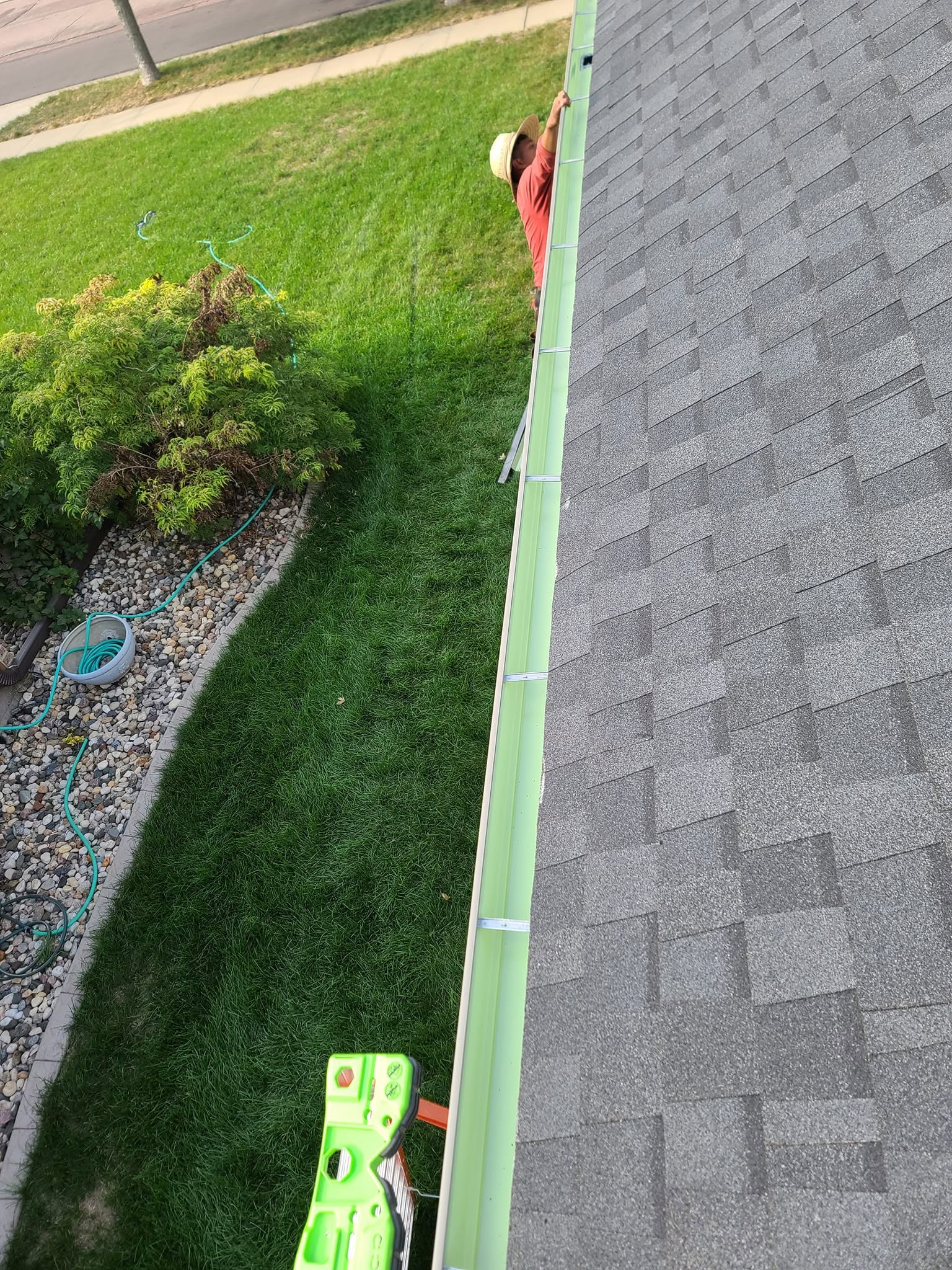 United Roofing & Siding gutter installation along a residential shingle roof in Sioux Falls, SD