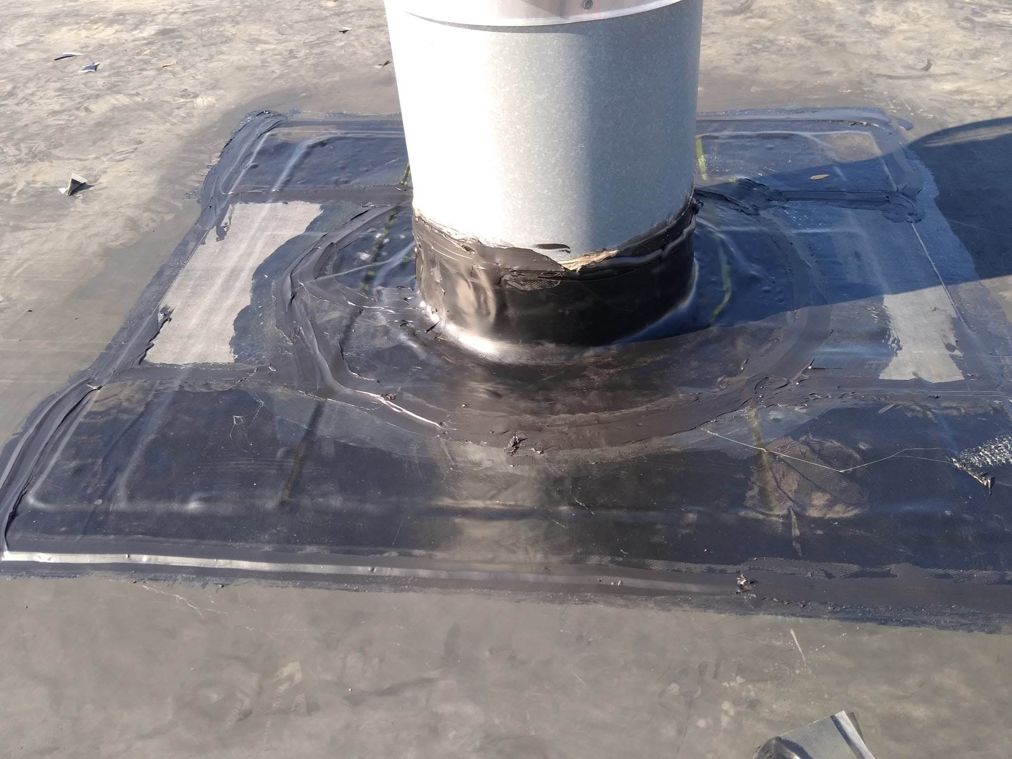 United Roofing & Siding rubber roofing vent flashing repair for a flat roof in Sioux Falls, SD